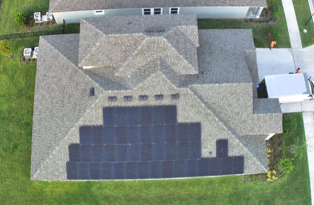 Aerial view of an all-black residential solar installation on a Nature Coast home by May Electric Solar